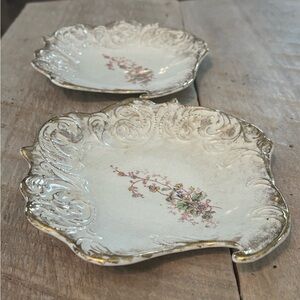 Set of two gold leafed dishes with crest on the back. No info available. #229.
